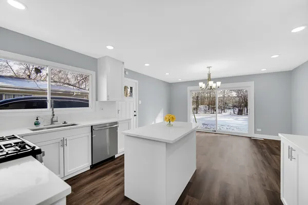 a kitchen with stainless steel appliances a sink stove and cabinets