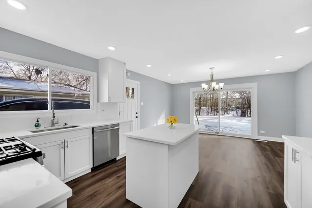 a kitchen with stainless steel appliances a sink stove and cabinets