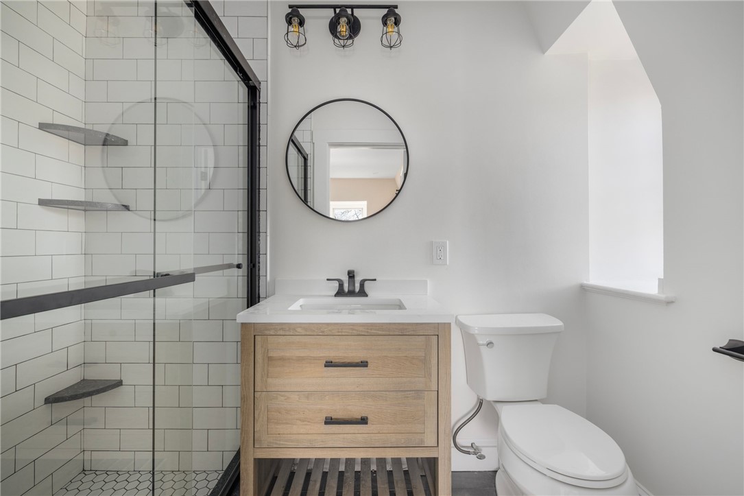 67 Perry Street, Unit 7 Newport, RI 02840 - Photo 21 of 27 Quaint updated bathroom. Small original window that is sealed.