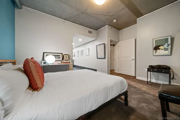 a bedroom with a bed and a dresser with bookshelf
