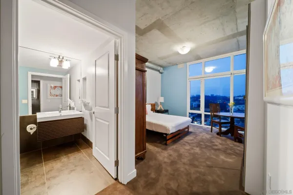 a bathroom with a tub and view of living room