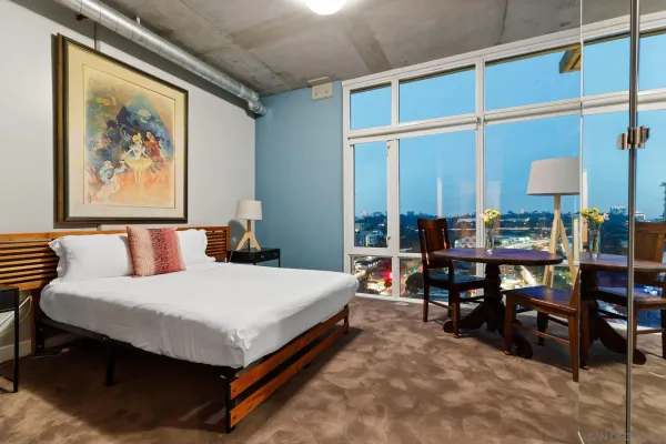 a bed room with a bed and a lamp on table