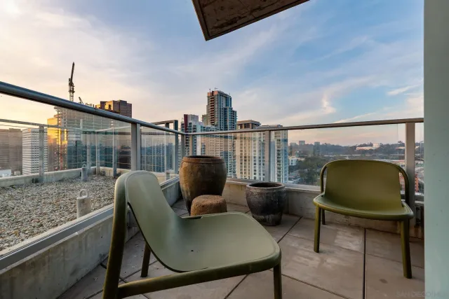 a bedroom with furniture and a large window