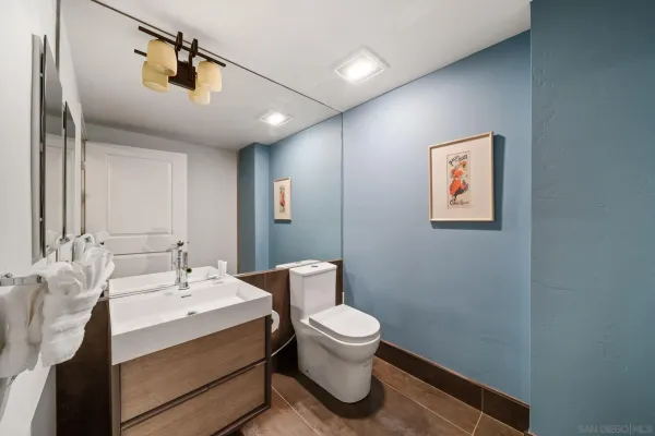 a bathroom with a bathtub sink mirror and toilet