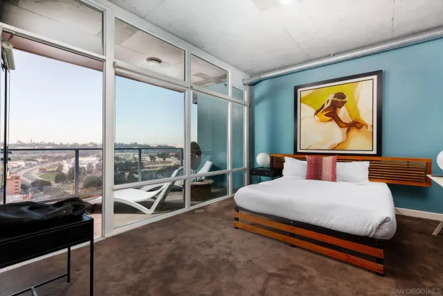 a bedroom with a bed and glass walk in closet