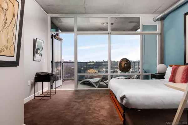 a bed room with a bed and a chair