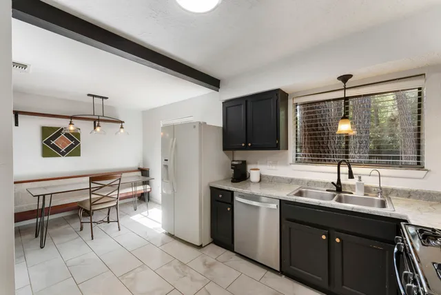 a kitchen with a sink cabinets and stainless steel appliances
