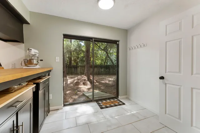 a kitchen with granite countertop a stove a sink and a cabinet