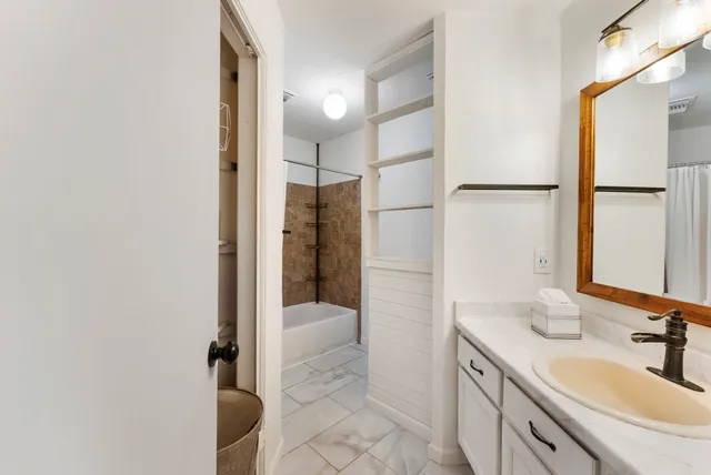 a bathroom with a sink and a mirror