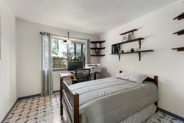 a bedroom with a bed and a window