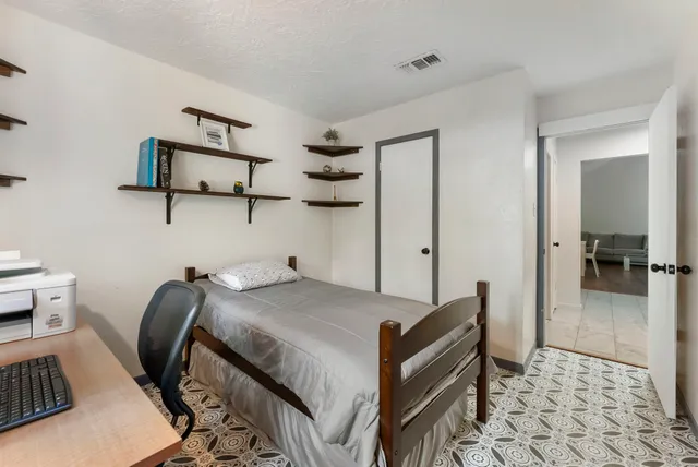 a bedroom with a bed and cabinets