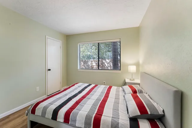 a bedroom with a bed and a window