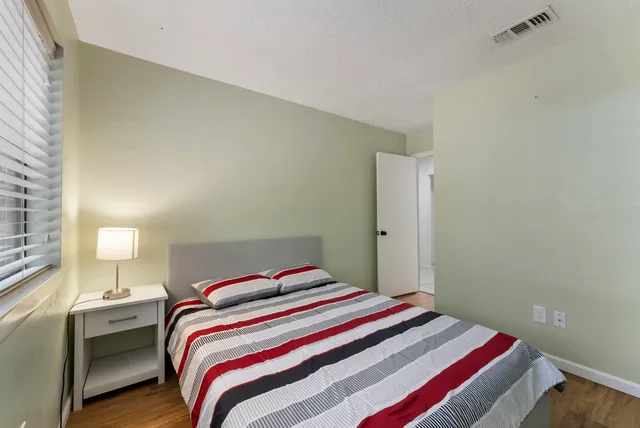 a bedroom with a bed and window