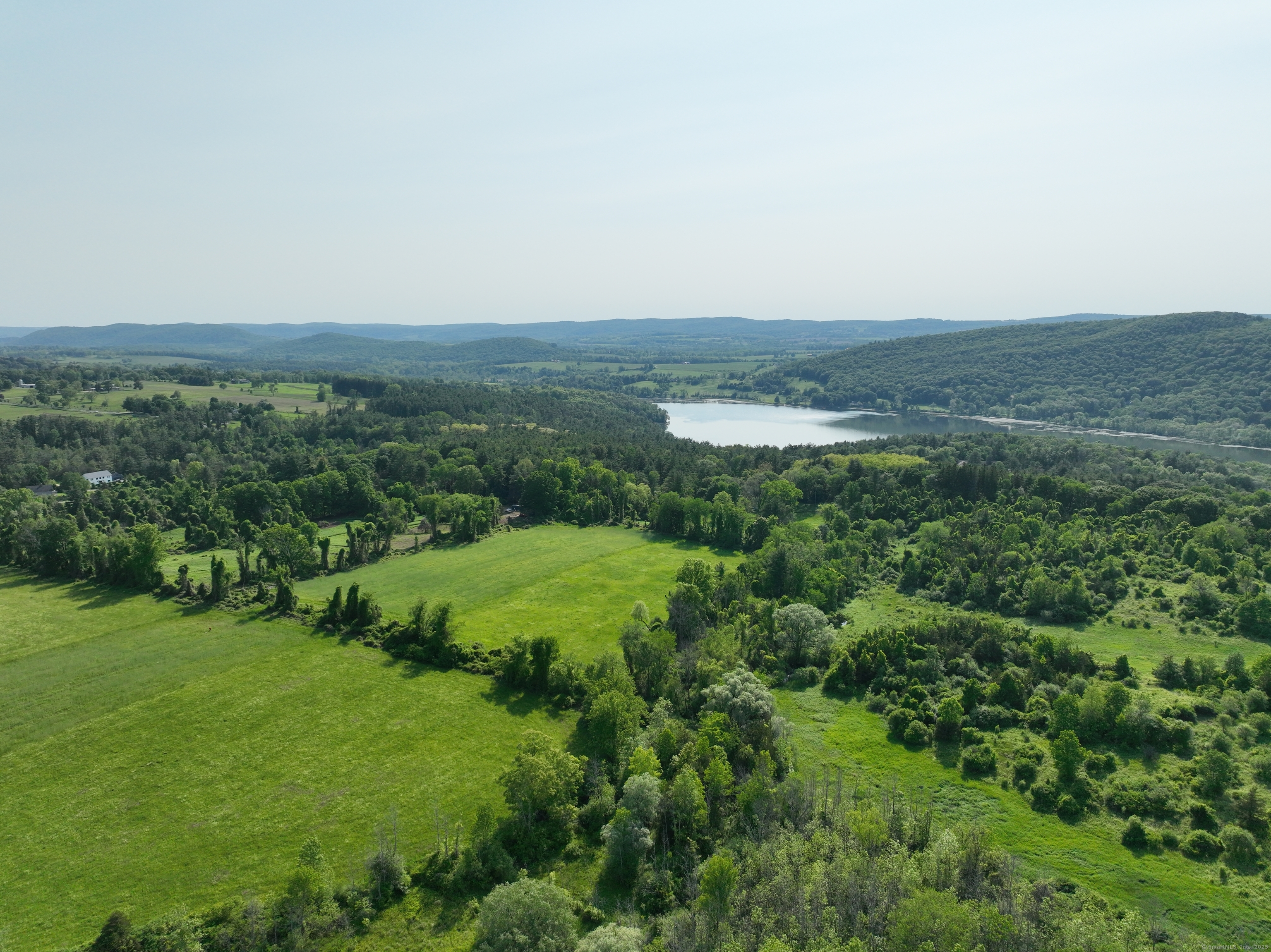 a view of a lush green field with a view of mountains and green space