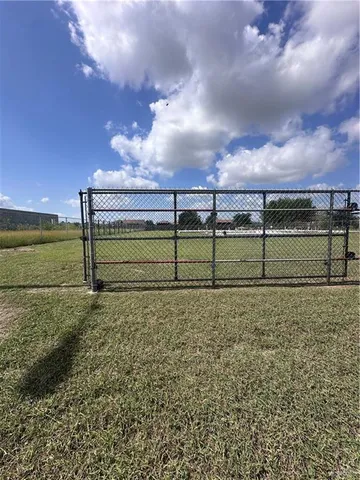 a view of a yard with wooden fence