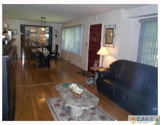 5 Rodney Road East Brunswick, NJ 08816 - Photo 2 of 8 a living room with furniture and a chandelier