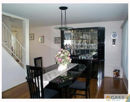 5 Rodney Road East Brunswick, NJ 08816 - Photo 3 of 8 a view of a dining room with furniture wooden floor and chandelier