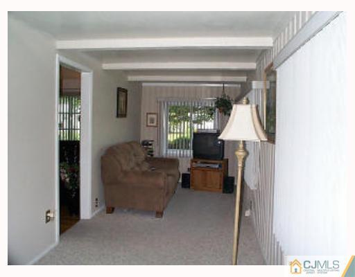 5 Rodney Road East Brunswick, NJ 08816 - Photo 5 of 8 a living room with furniture and a window