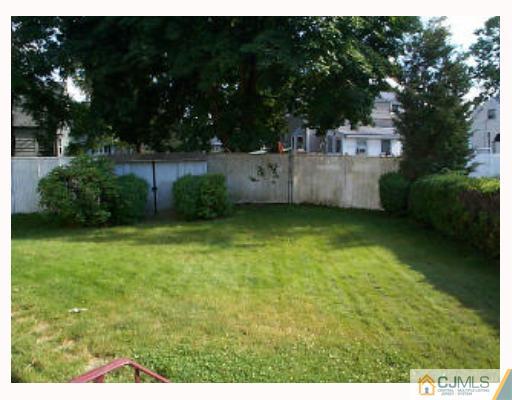 5 Rodney Road East Brunswick, NJ 08816 - Photo 8 of 8 a backyard of a house with lots of green space