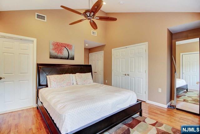 176 Undercliff Avenue Edgewater, NJ 07020 - Photo 12 of 22 a bedroom with a bed and a chandelier