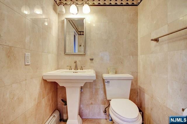 176 Undercliff Avenue Edgewater, NJ 07020 - Photo 13 of 22 a white toilet sitting next to a bathroom sink