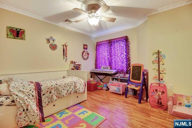 176 Undercliff Avenue Edgewater, NJ 07020 - Photo 15 of 22 a bedroom with a bed and wooden floor