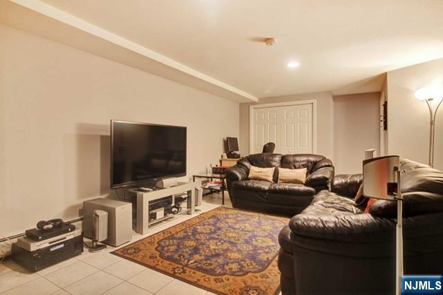 176 Undercliff Avenue Edgewater, NJ 07020 - Photo 18 of 22 a living room with furniture and a flat screen tv