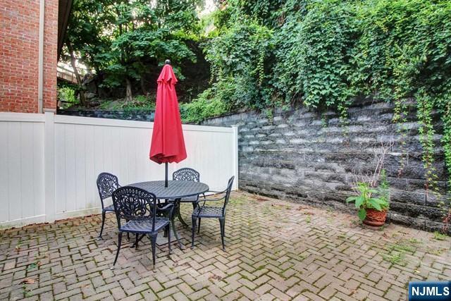 176 Undercliff Avenue Edgewater, NJ 07020 - Photo 22 of 22 a view of a backyard with furniture and a slide
