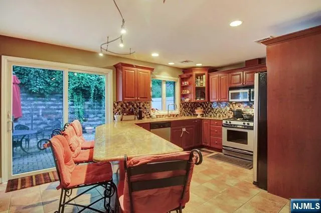 a kitchen with stainless steel appliances granite countertop a stove and a refrigerator