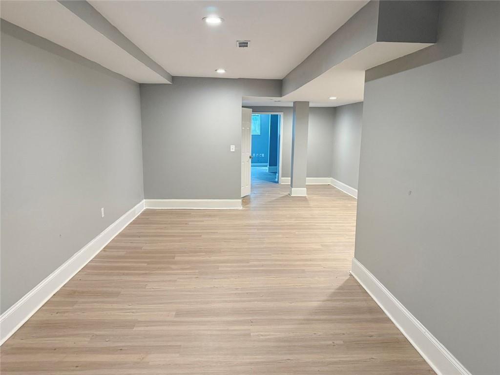 4330 Stonewall Tell Road Atlanta, GA 30349 - Photo 31 of 39 a view of an empty room with wooden floor