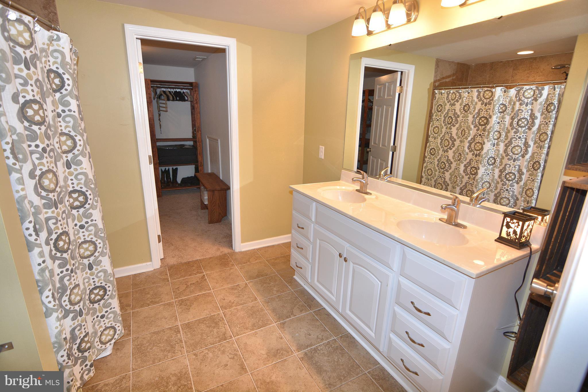 1320 Wilson Road Huntingtown, MD 20639 - Photo 23 of 29 Dual sinks, walk in closet and tiled shower