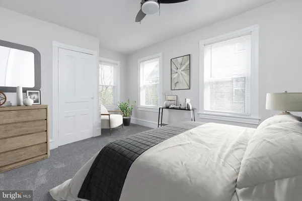 a spacious bedroom with a bed and potted plant