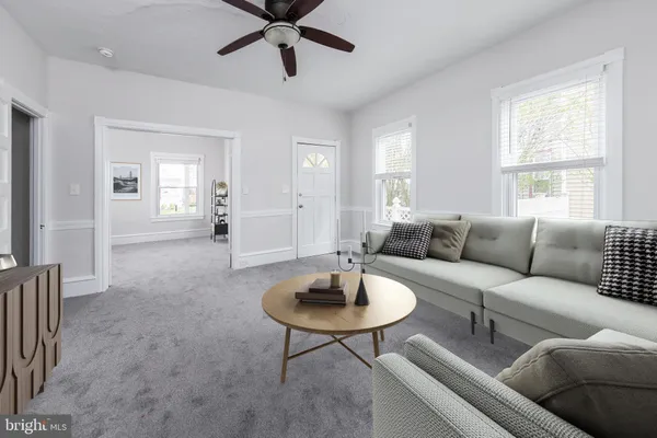 a living room with furniture a window and a chandelier