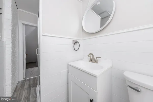 a bathroom with a sink a toilet and a mirror