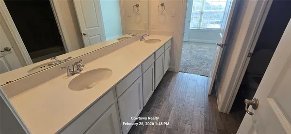 a bathroom with a double vanity sink and a mirror