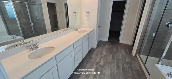 a bathroom with a double vanity sink and mirror