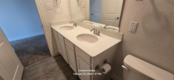 a bathroom with a sink toilet and mirror