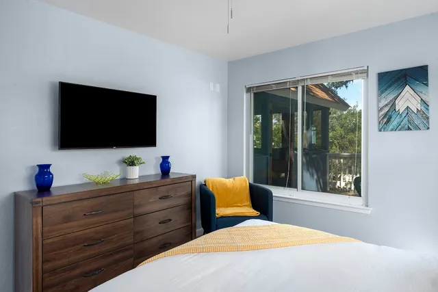 a bedroom with a bed and window