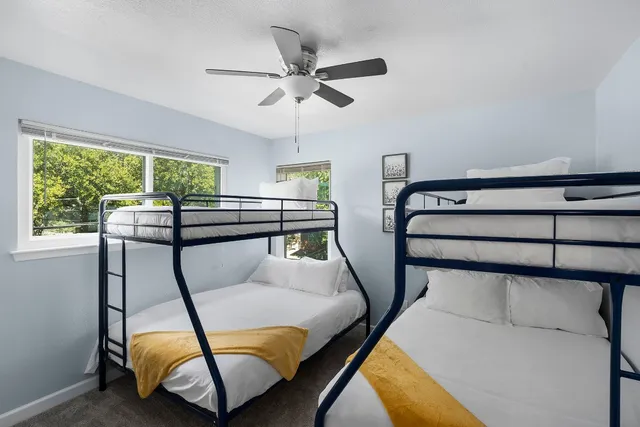 a living room with furniture and a open kitchen view