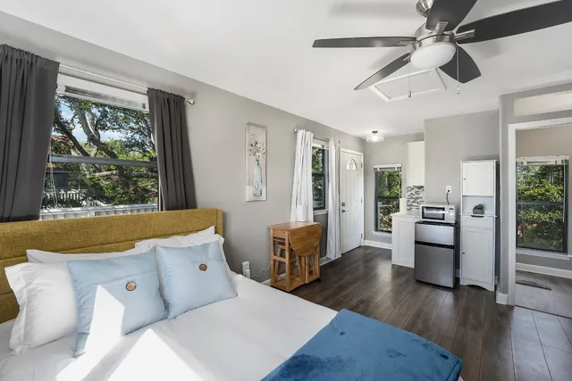 a bedroom with a bed and a flat screen tv