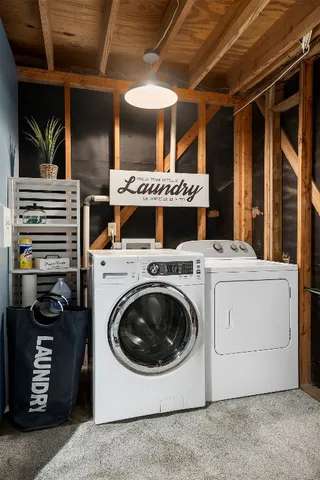 a view of a roof deck with wooden fence and a bench