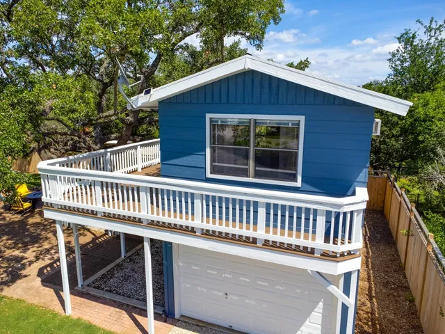 an aerial view of a house with swimming pool and mountains