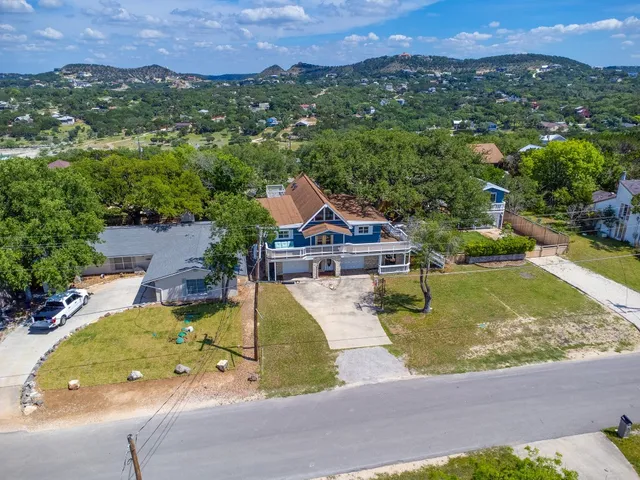 an aerial view of a house with swimming pool and a yard
