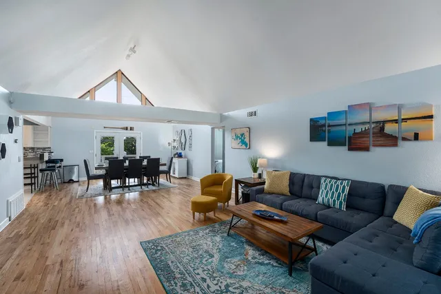 a kitchen with white cabinets stainless steel appliances and a window
