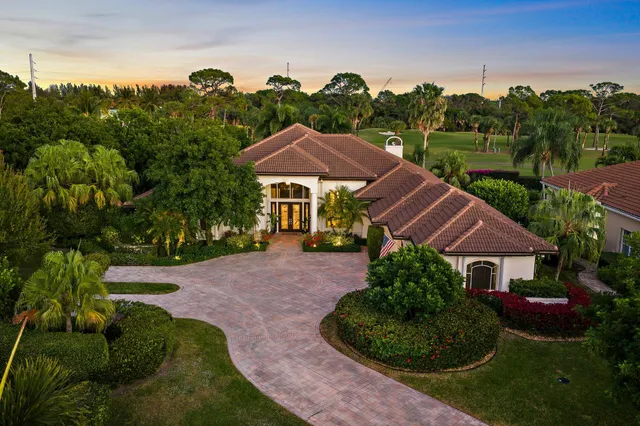 an aerial view of a house with garden space and street view