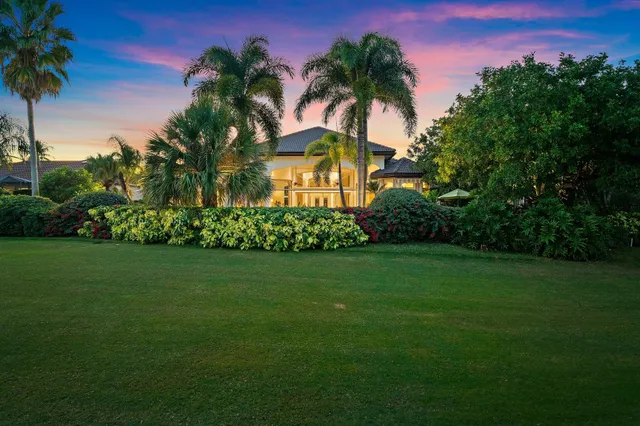 a living room with furniture a large window and a chandelier