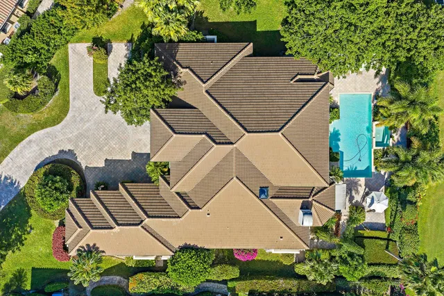 a living room with furniture a large window and wooden floor