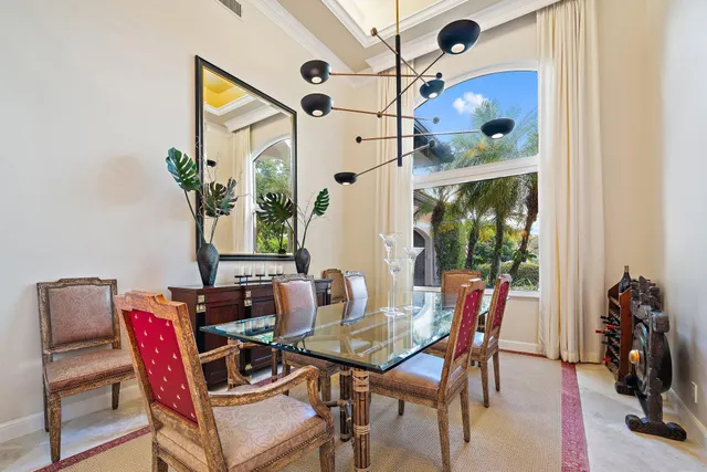 a spacious bedroom with a bed and glass walk in closet