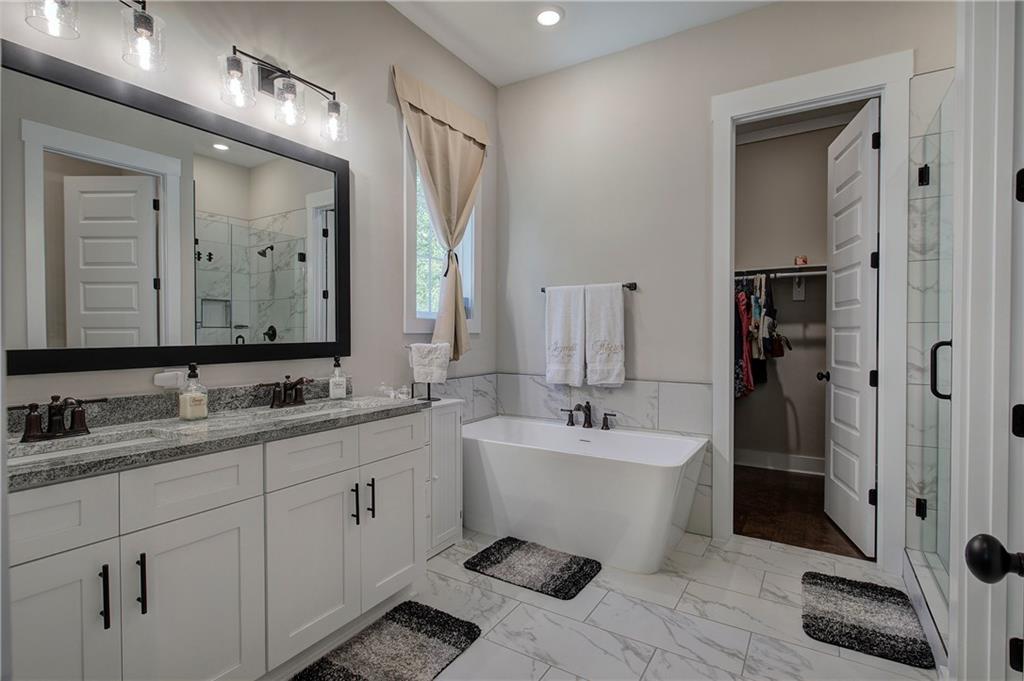 503 London Road Ball Ground, GA 30107 - Photo 23 of 55 a spacious bathroom with a double vanity sink mirror and bathtub
