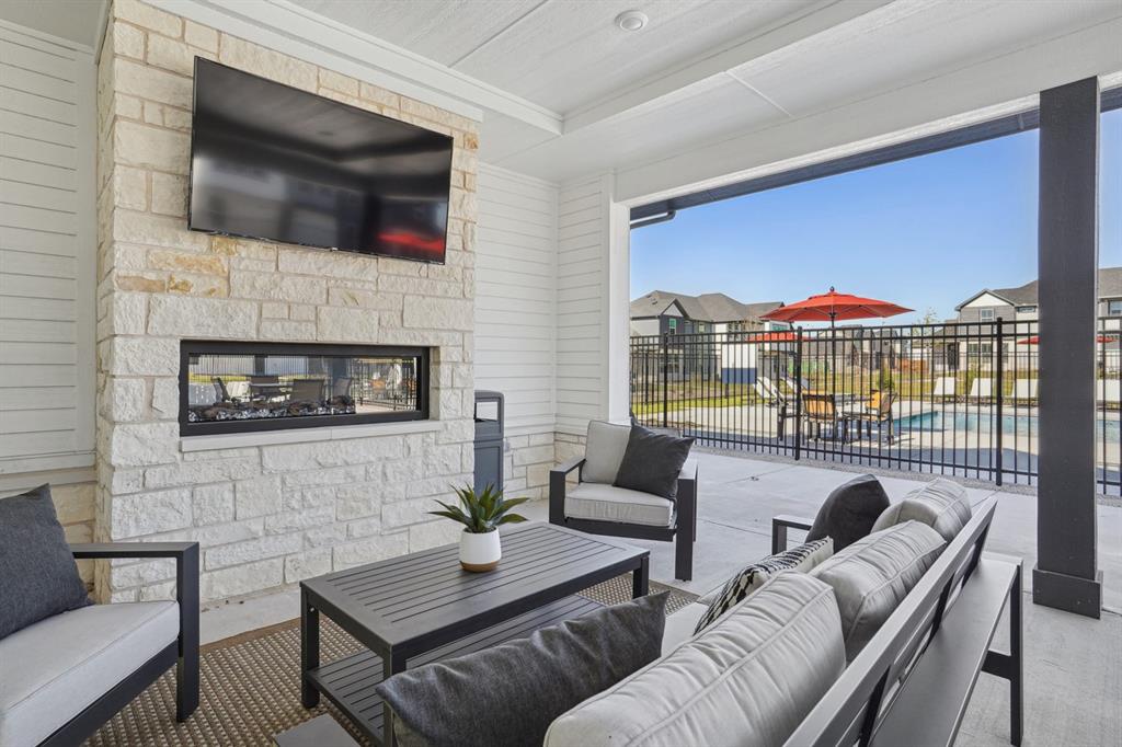 3007 Canvas Way Anna, TX 75409 - Photo 15 of 21 a living room with furniture a flat screen tv and a fireplace